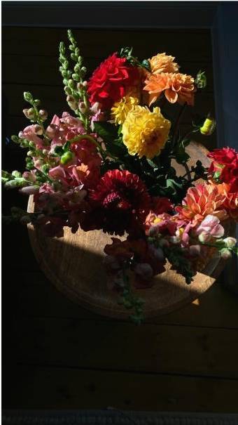 Workshop participants smiling with bouquets